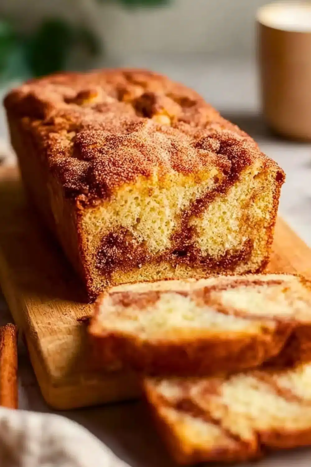 Buttery snickerdoodle bread fresh out of the oven with a sprinkle of cinnamon sugar.