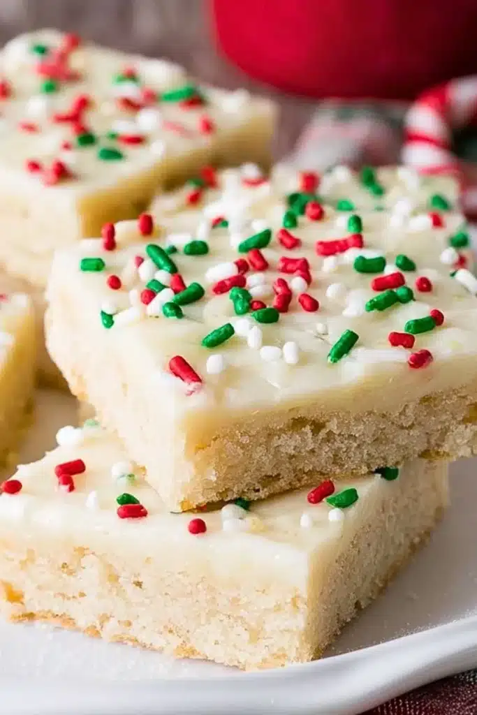 Delicious Christmas sugar cookie bars topped with festive sprinkles