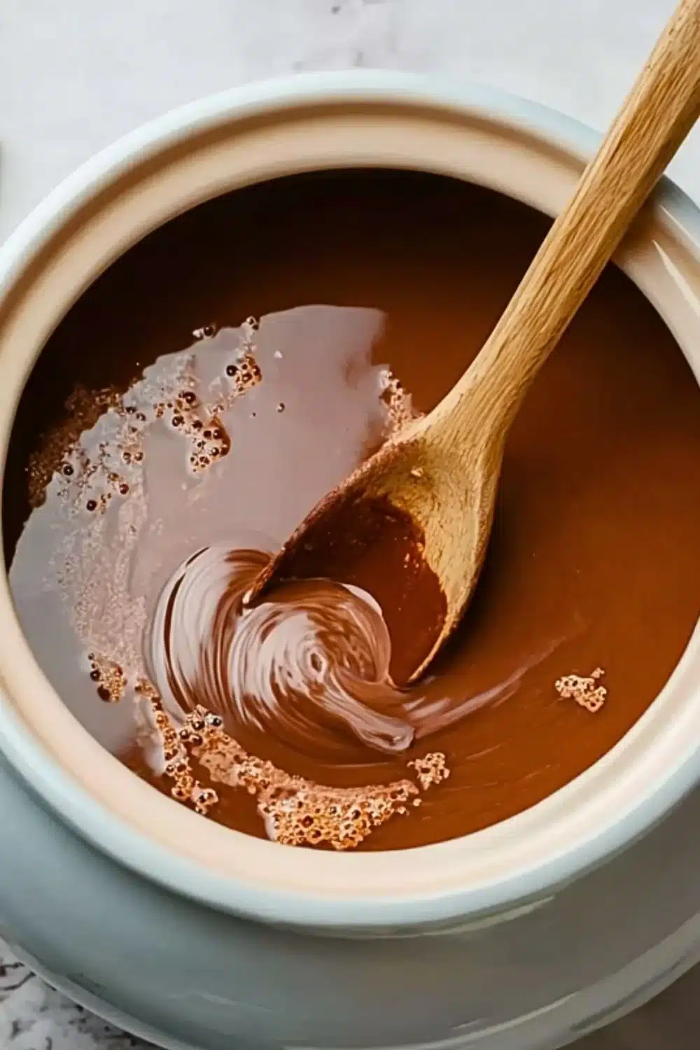 Crock Pot Hot Chocolate served in a mug with marshmallows and chocolate drizzles