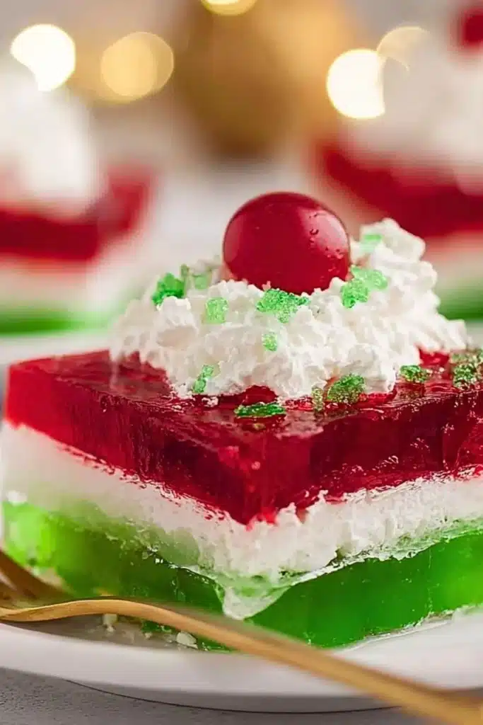 Colorful Easy Layered Christmas Jello dessert in festive holiday serving dish