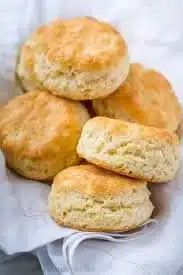 Freshly baked homemade biscuits on a wooden table