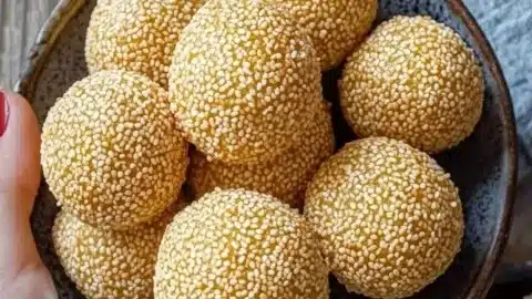 Plate of homemade crispy sesame balls (Jian Dui) ready for festive occasions.