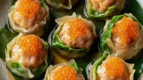 Vegan Lucky Money Bag Dumplings served on a plate with dipping sauce