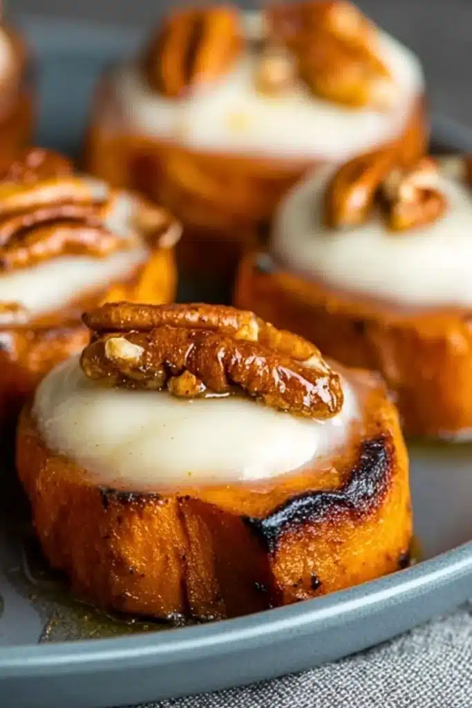 Maple roasted sweet potato bites served in a bowl with garnishes.
