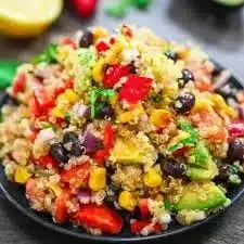 Colorful Mexican Street Corn Quinoa Salad topped with cilantro and lime