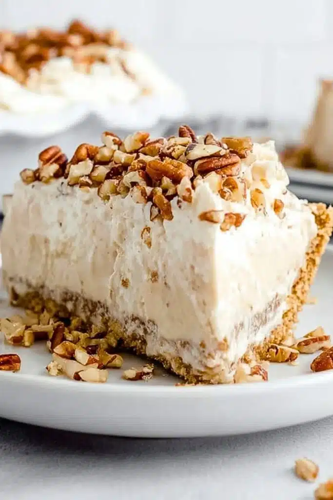 Delicious slice of pecan cream pie topped with whipped cream