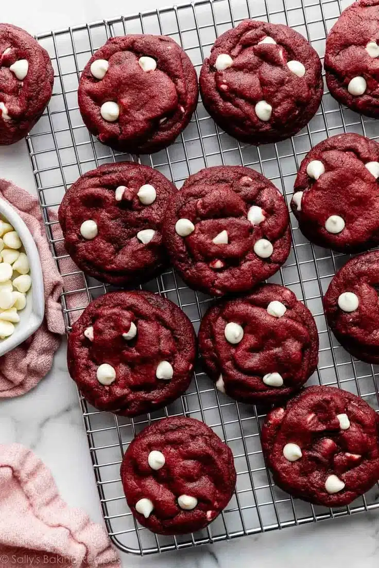 Delicious red velvet cookies with white chocolate chips on a baking tray