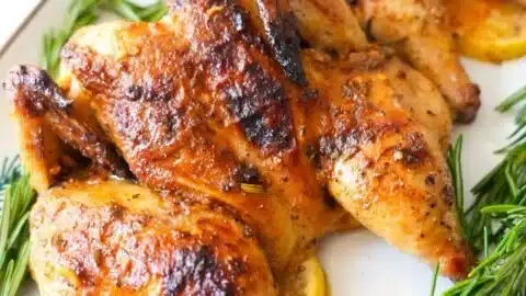 Delicious roasted Cornish hens garnished and served on a platter