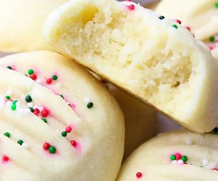 A plate of freshly baked shortbread cookies, golden and crumbly.