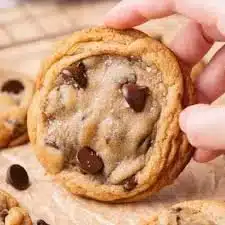 Freshly baked soft and chewy chocolate chip cookies on a cooling rack