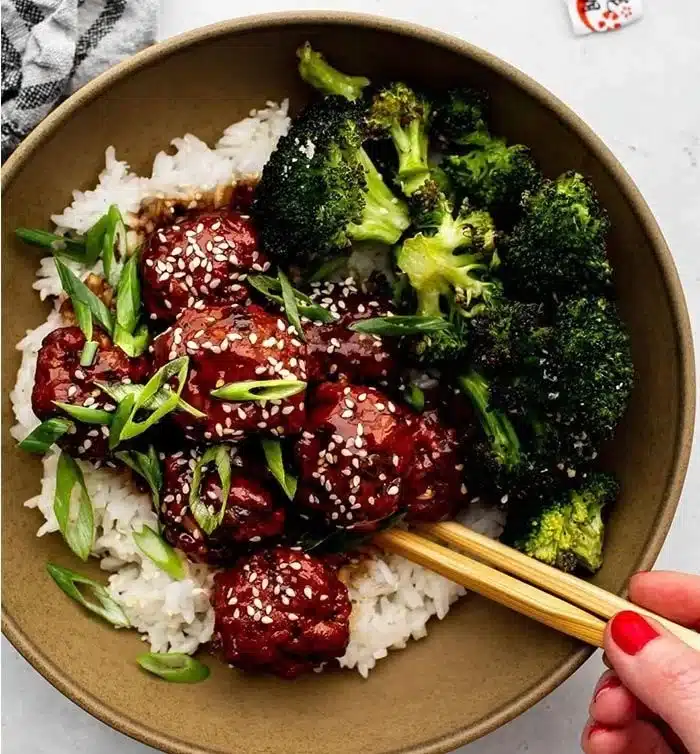 Delicious Sticky Mongolian Beef Meatballs served on a plate with garnish.