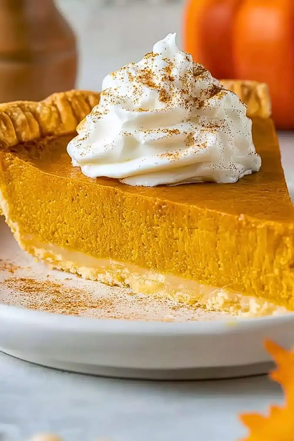 Delicious slice of pumpkin pie topped with whipped cream