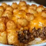 Delicious Tater Tot Casserole with Ground Beef topped with cheese