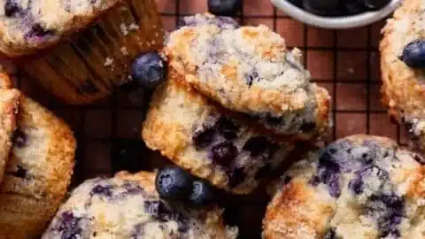 Bakery style blueberry muffins fresh out of the oven with juicy blueberries.