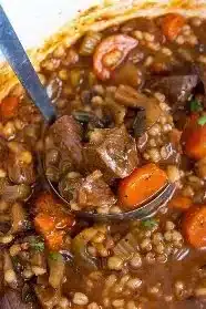 Delicious bowl of beef barley soup with tender beef, barley, and vegetables