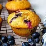 Freshly baked blueberry muffins with juicy blueberries on a wooden table