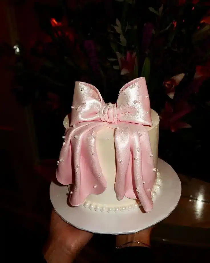 Chloé Lorenz birthday cake decorated with colorful sprinkles and candles.