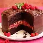 Delicious Chocolate Raspberry Cake layered with fresh raspberries and chocolate frosting.