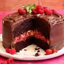 Delicious Chocolate Raspberry Cake layered with fresh raspberries and chocolate frosting.