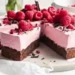 Delicious Chocolate Raspberry Mousse Cake topped with fresh raspberries