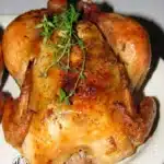 Roasted Cornish Hens with herbs and spices on a rustic table