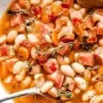A flavorful bowl of easy ham and bean soup garnished with herbs