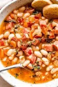 A flavorful bowl of easy ham and bean soup garnished with herbs