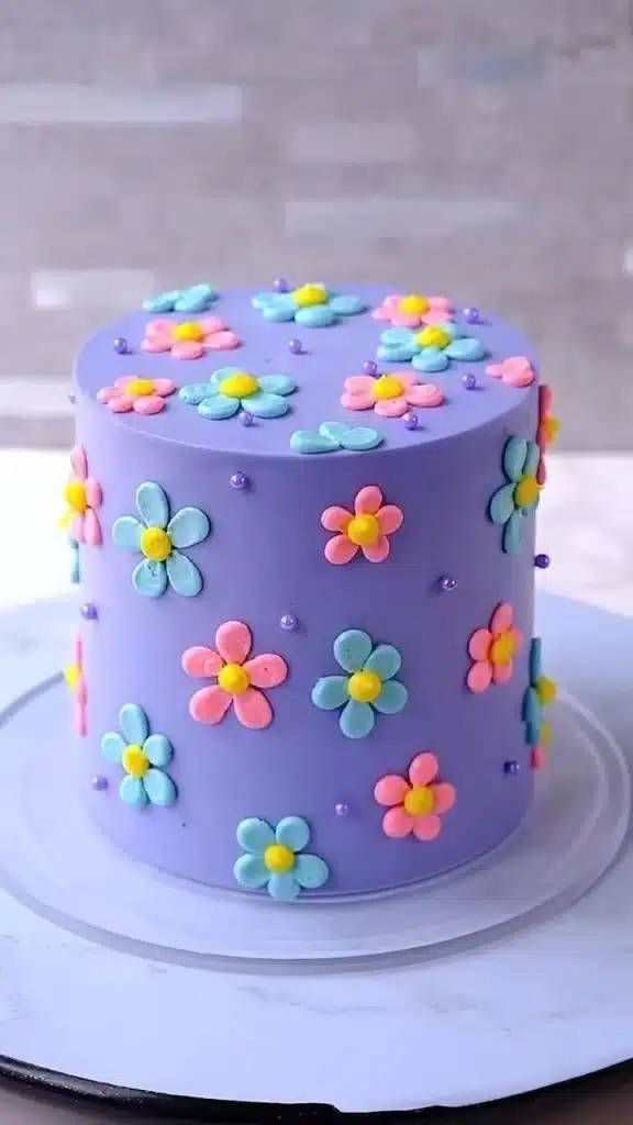 Delicious Festive Floral Cake adorned with colorful edible flowers.