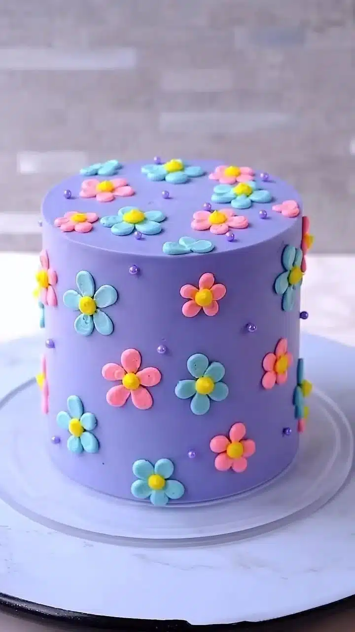 Delicious Festive Floral Cake adorned with colorful edible flowers.