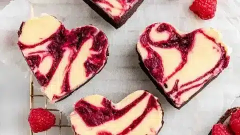 Heart shaped brownies decorated with chocolate sprinkles on a wooden table