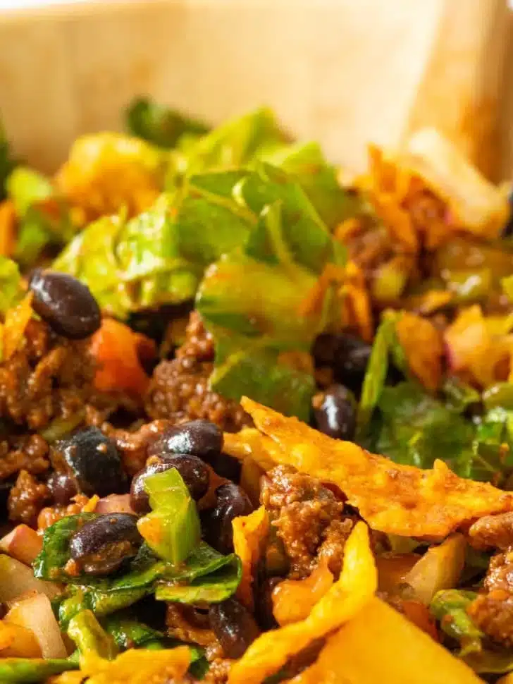 Delicious Hearty Nacho Cheese Salad topped with fresh ingredients and creamy cheese