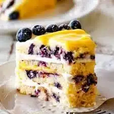 Delicious Lemon Blueberry Cake topped with fresh blueberries and lemon zest.