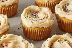 Deliciously fluffy perfect vanilla cupcakes topped with creamy frosting.