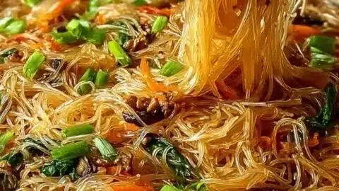 Delicious rice noodle stir-fry with colorful vegetables and savory sauce.
