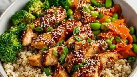 Delicious sticky chicken bowl with rice and vegetables
