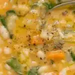 Bowl of the best white bean soup garnished with herbs