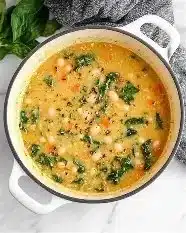 Bowl of delicious Tuscan white bean soup with fresh herbs on top