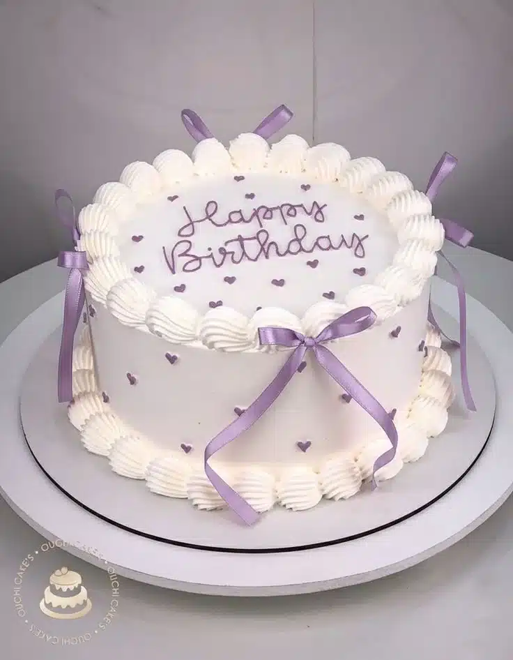 A beautifully decorated vintage cake with intricate details and soft pastel colors.