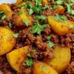 Delicious Aloo Keema served with rice and garnished with fresh cilantro.
