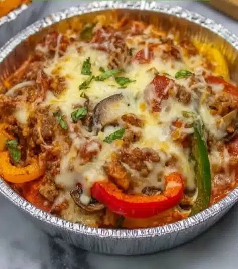 Delicious crustless pizza bowl filled with fresh toppings and cheese.