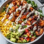 Delicious grilled shrimp bowl topped with fresh vegetables and seasonings