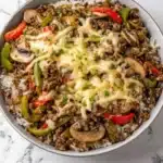 Ground Beef Philly Cheesesteak sandwich with melted cheese and peppers