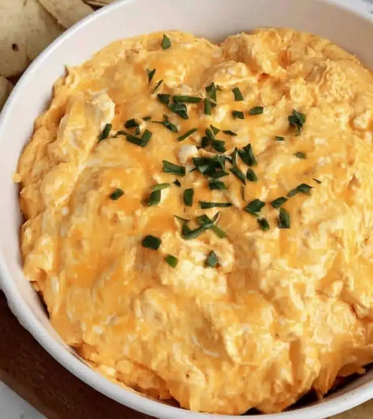High protein buffalo chicken dip served in a bowl with tortilla chips
