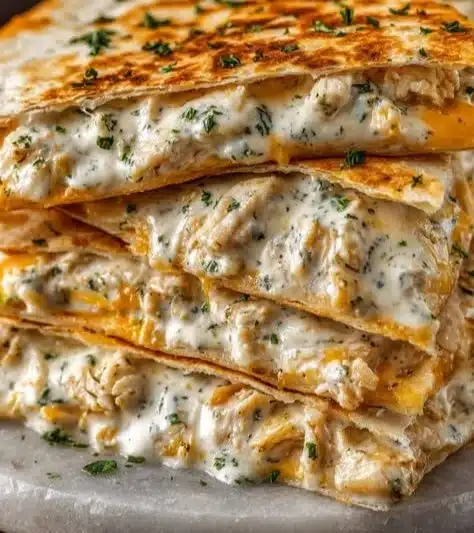 High-Protein Chicken Ranch Quesadilla served with fresh toppings and ranch dressing.