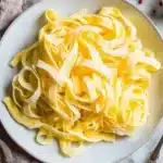 Bowl of homemade keto egg noodles served with sauce and herbs