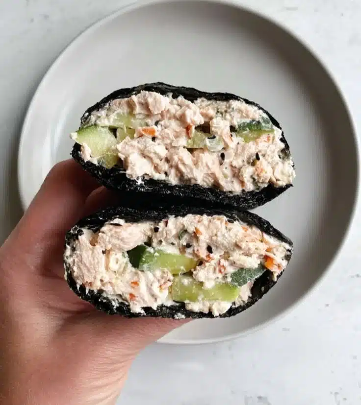 Tuna salad nori wraps served on a plate, garnished with sesame seeds.