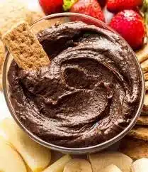 Delicious chocolate hummus served with fruits and crackers.
