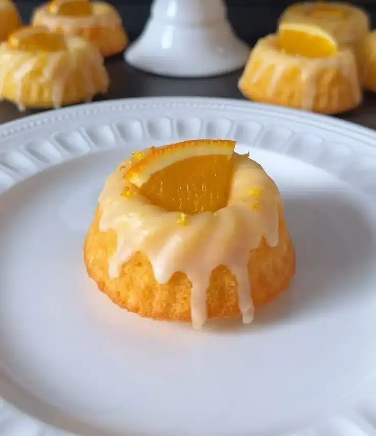 Delightful mini orange bundt cakes garnished with orange zest and icing