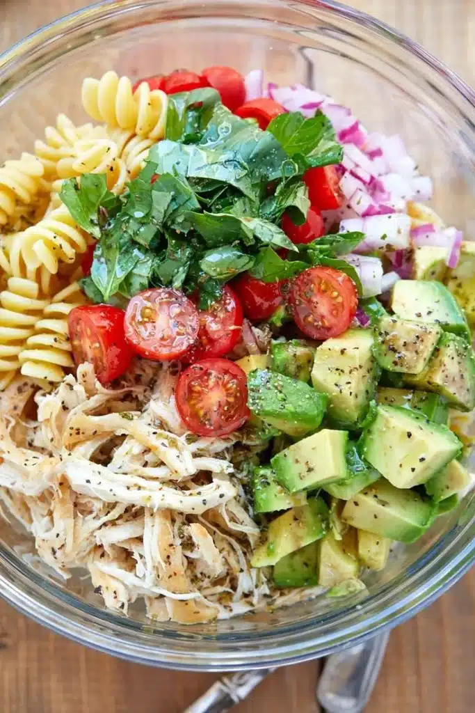 Healthy chicken pasta salad with fresh vegetables and a light dressing