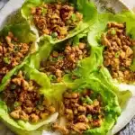 Plate of PF Chang's Chicken Lettuce Wraps served with dipping sauce